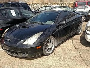 ugly black celica with aftermarket wheels