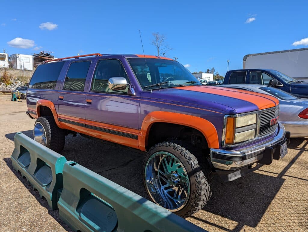 Orange and Purple suburban lifted on mall crawlers.