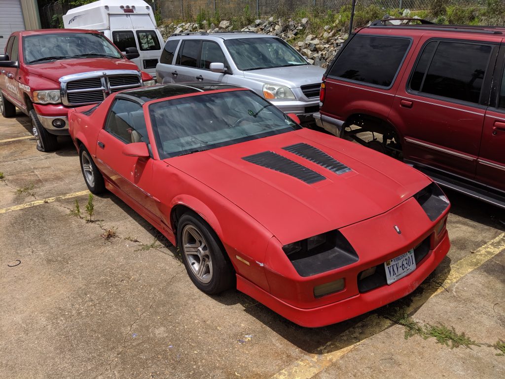 red iroc camaro with faded paint