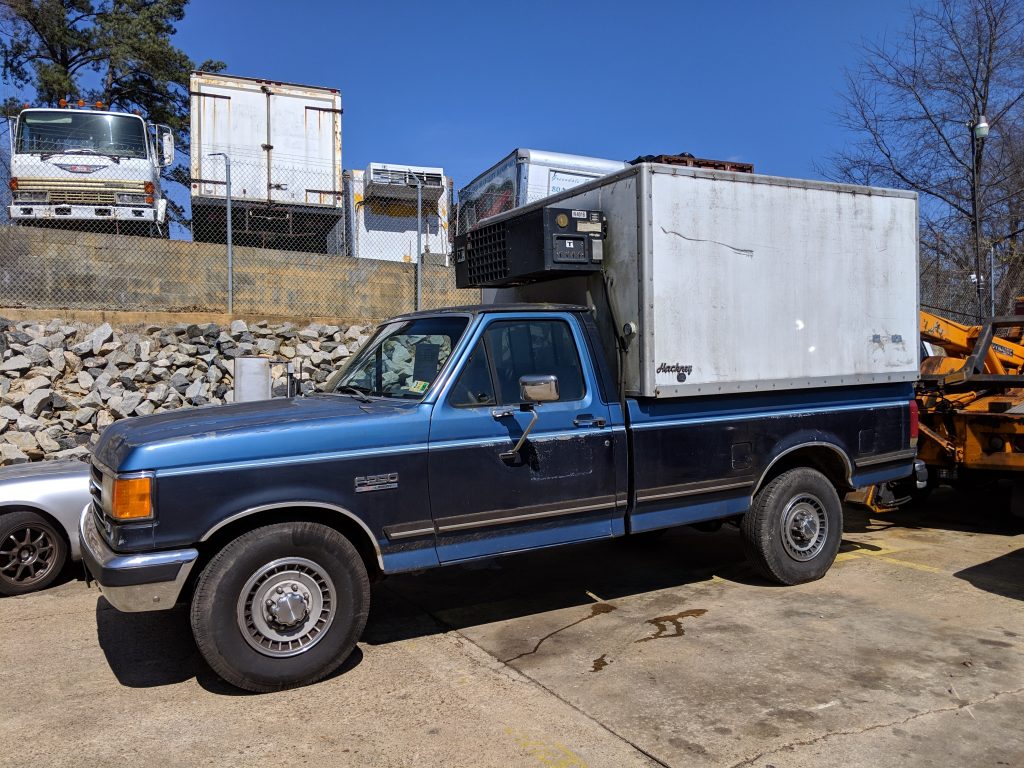 blue ford pickup with reefer unit in bed