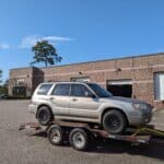 silver subaru forester on a trailer outside of fortune autos coilover facility in powhatan va