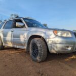 front view of rallycross style subaru forester on 15" wheels with aggressive dirt tires installed