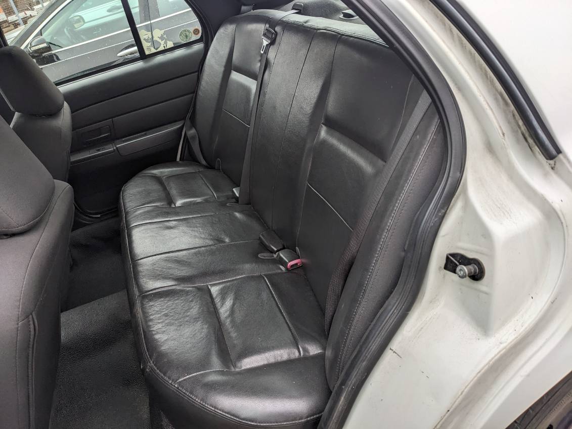 view of back seat in a police crown vic thru the open door
